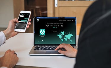 a man is holding a cell phone and a computer using ohaio chat