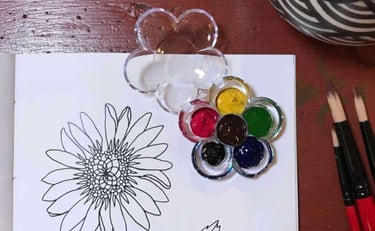 Close up of keketerehe colouring page, with small flower shaped paint palette and brushes
