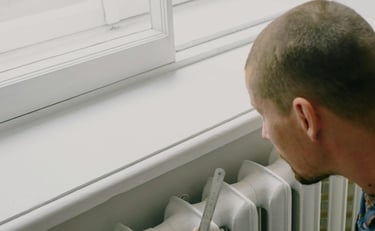 a man in a blue shirt is holding a knife and a knife in his hand