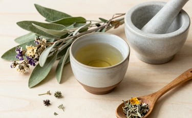 a table with a bowl of soup and a jar of herbs