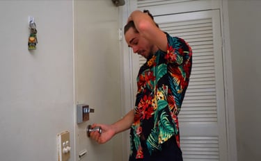 a man in a hawaiian shirt is holding a keychain