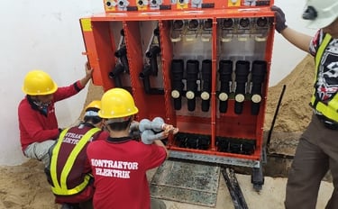 Electricians installing switchgear in a TNB substation