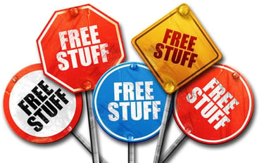 A collection of colorful red, blue, and yellow street signs with the text free stuff.