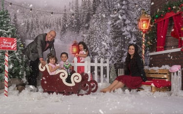 a family posing for a photo in a snowy scene