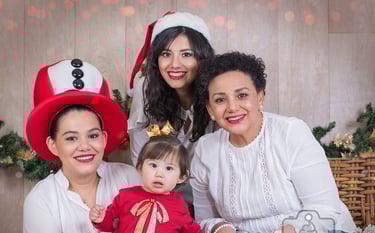 a family posing for a photo with a christmas tree