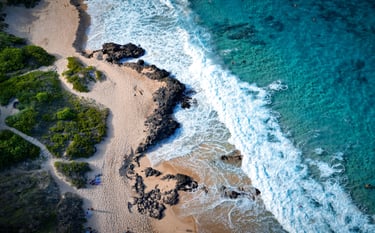a beach with a sandy beach and a blue sky