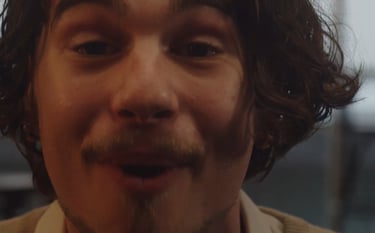 a man with a mustache and a tie on his neck