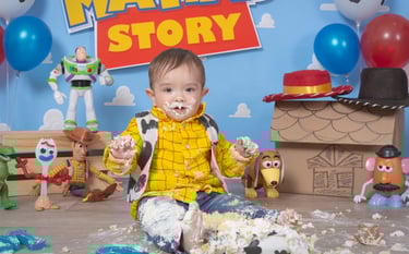 a baby boy in a yellow shirt and blue jeans