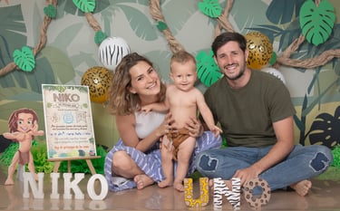 a man and woman sitting on a table with a sign that says nikkoo