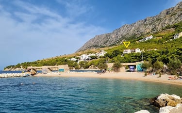 The photo depicts the house and yard with the pool as seen from the western sunny terrace.