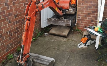 Digger operator preparing foundation for construction site in Oldbury