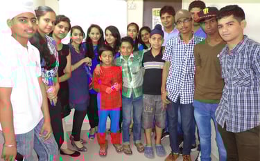 a group of people standing in front of a white wall