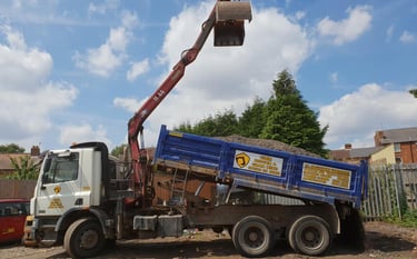 CMR grab lorry loaded with gravel on construction site in Dudley