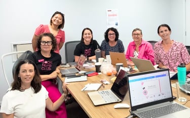 Small business owners participating in a beginner-friendly digital workshop with laptops notebooks