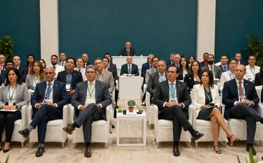 A grand assembly of South American / Colombian professionals during an environmental and political summit in Bucaramanga. Wide shot, elegant lighting, professional community vibe. Palette uses deep teal and off-white tones.