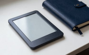 A minimalist North American lifestyle shot of a modern e-reader and a leather notebook on a white desk, soft morning light, sophisticated and intellectual mood, steel blue and dark navy tones.