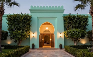 A luxury hotel garden and entrance in Marrakech at dusk. The lighting is warm and sophisticated. The composition highlights the pristine architectural details. The brand colors of deep spruce and light mint create an image of unwavering reliability.