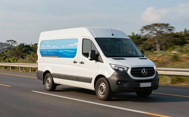 A modern, white delivery van with ocean blue detailing driving along a well-maintained highway in a Brazilian landscape. The lighting is crisp afternoon sun, emphasizing speed and efficiency. The vehicle looks pristine and reliable.