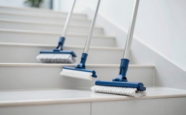 A close-up shot of professional cleaning tools and a brightly polished staircase in a corporate building. The lighting is crisp and clean. The color palette emphasizes #1A2C3C and #F4F8FC. The vibe is one of efficiency and high-quality maintenance.
