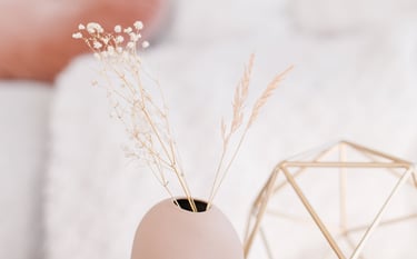 a vase with a vase of flowers in a room