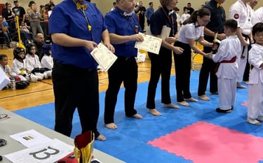 a man in a blue shirt is holding a certificate
