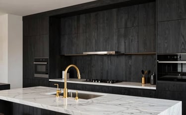 A luxury modern kitchen interior. Features dark charcoal modular cabinetry, white marble island, and elegant gold faucets. Meticulous detail on wood textures and lighting. Professional interior photography in a premium South Asian residence.