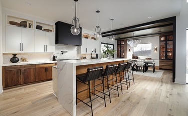 a kitchen with a large island and a bar stool