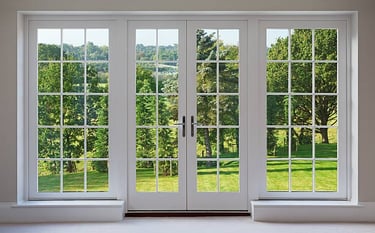 a room with a large window and a view of a field