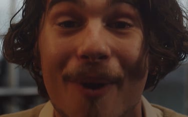 a man with a mustache and a tie on his neck
