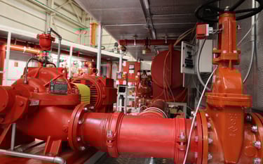 a red fire hydrant with a red fire hydrant in the background