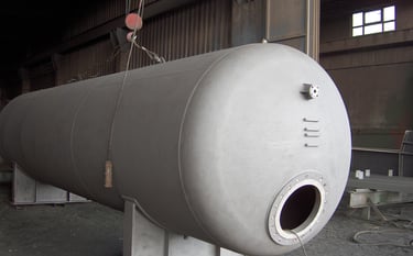 a large metal tank sitting in a warehouse