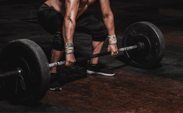Lifting weight bar at gym