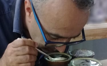 a man in glasses and a blue shirt is eating a meal