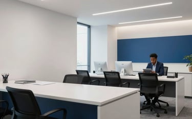A minimalist, high-end financial office interior in East Africa with a clean aesthetic. A person is seen in the background using a tablet, with soft lighting and professional blue accents throughout the room.