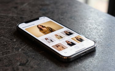 A close-up of a high-end smartphone resting on a dark marble surface, displaying a sleek social media interface with gold-themed fashion advertisements, soft natural light from a window in a North American luxury apartment, professional photography.