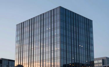 A sleek, modern commercial glass building reflecting a twilight sky. The lighting is sophisticated, using deep tones like #1E272C and #4A6572. The image conveys unwavering reliability and modern architectural excellence.