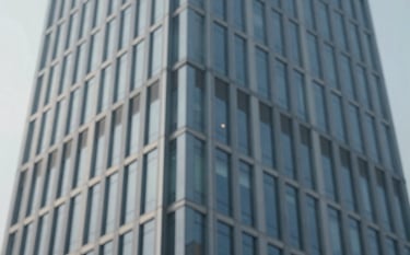 Abstract architectural shot of a modern skyscraper's steel and glass facade, symbolizing organizational structure and efficiency. Clean lines, sophisticated lighting, emphasizing #778DA9 and #1B263B tones.