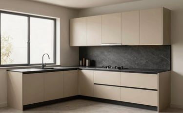 A high-resolution photography of a minimalist L-shaped modular kitchen in a South Asian home. Features champagne-colored sleek cabinets, charcoal countertops, and soft natural light from a window. The style is modern and luxury-focused with a clutter-free environment.