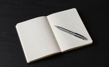 A top-down view of a minimalist ebony black desk. A silver grey pen rests on a soft off-white planner. The lighting is crisp and professional, highlighting the clean textures and authoritative contractor aesthetic.