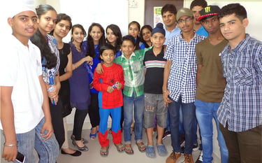 a group of people standing in front of a white wall