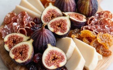 A cozy setup featuring a grazing board paired with a cup of coffee, highlighting the coffee color text theme.