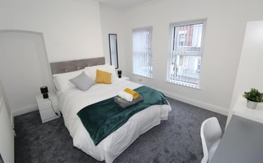 bedroom with bed and white walls