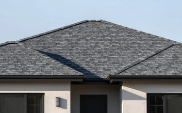 A high-resolution photograph of a modern residential home in Torrance with a perfectly installed charcoal grey asphalt shingle roof. The lighting is bright afternoon sun, highlighting the modern craftsmanship and texture. The sky is clear. Palette hints: #1C2833 and #4A6572 tones in the architecture.