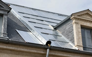 Close-up photography of professional zinc work being installed on a classic French building roof. Sharp focus on the craftsmanship and materials, natural outdoor light, modern silver and grey tones.