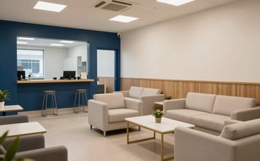 A clean and professional community center interior in a South Asian / Indian city, with warm lighting and a trustworthy atmosphere. Steel blue and soft off-white furniture accents create a modern, welcoming space.