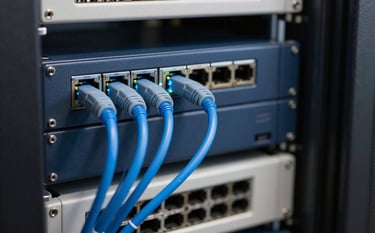 A close-up photograph of modern network equipment and glowing blue fiber optic cables in a clean Brazilian server room. The lighting is professional and sleek, highlighting the dark blue and off-white infrastructure of a high-end telecommunications facility.