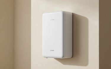 An interior shot of a minimalist utility room featuring a sleek, wall-mounted energy storage battery. The lighting is soft off-white with muted gold accents on the walls.