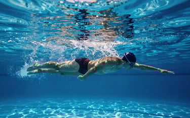 A cinematic underwater shot of a single swimmer in a sleek streamline position, captured in a pool with #367C8A blue water and bright #E6F5F8 light rays filtering from the surface. Professional lighting emphasizing the athlete's form and technical precision.