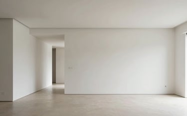 A professional wide-angle interior photograph of a modern Spanish home renovation. The scene highlights pristine white plasterboard walls and a minimalist living room design with sharp, clean lines and elegant lighting. Soft natural light illuminates the smooth surfaces. Professional architectural style.
