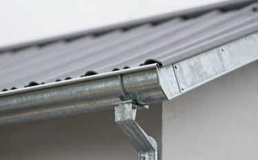 A close-up shot of professional galvanized steel gutters installed on the edge of a clean, modern roof. The image reflects daylight, emphasizing the robust and precise craftsmanship. The aesthetic is industrial and clean, using tones of #90A4AE and #ECEFF1.